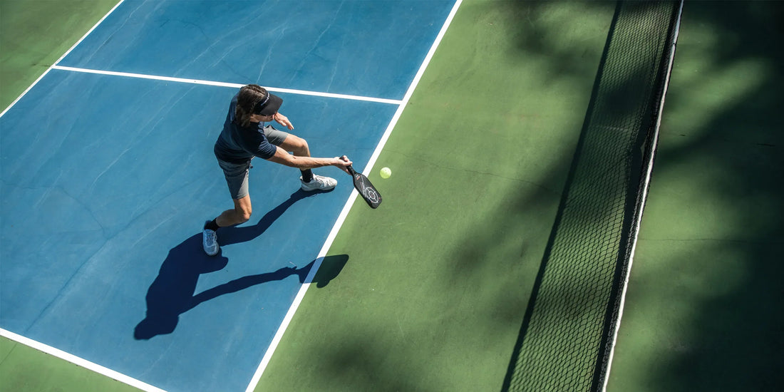 Person on a pickleball court playing pickleball while wearing Superfeet insoles.