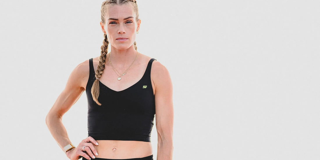 Image of Olympian Colleen Quigley wearing black athletic gear in front of a white backgroun