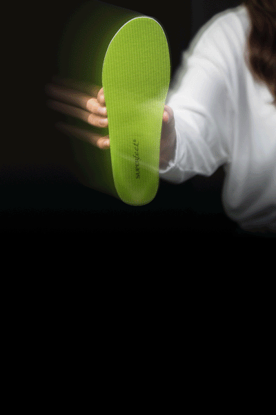 Gif of people holding different green, blue, and black all-purpose Superfeet insoles.