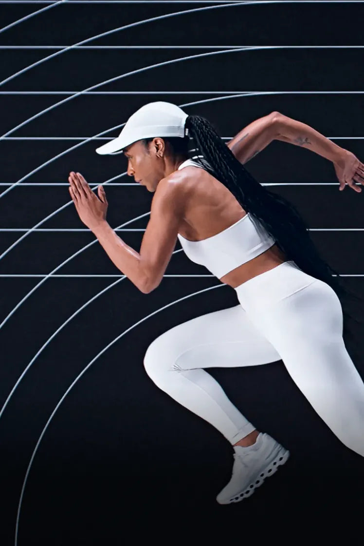 Woman running on a track with a black and white background