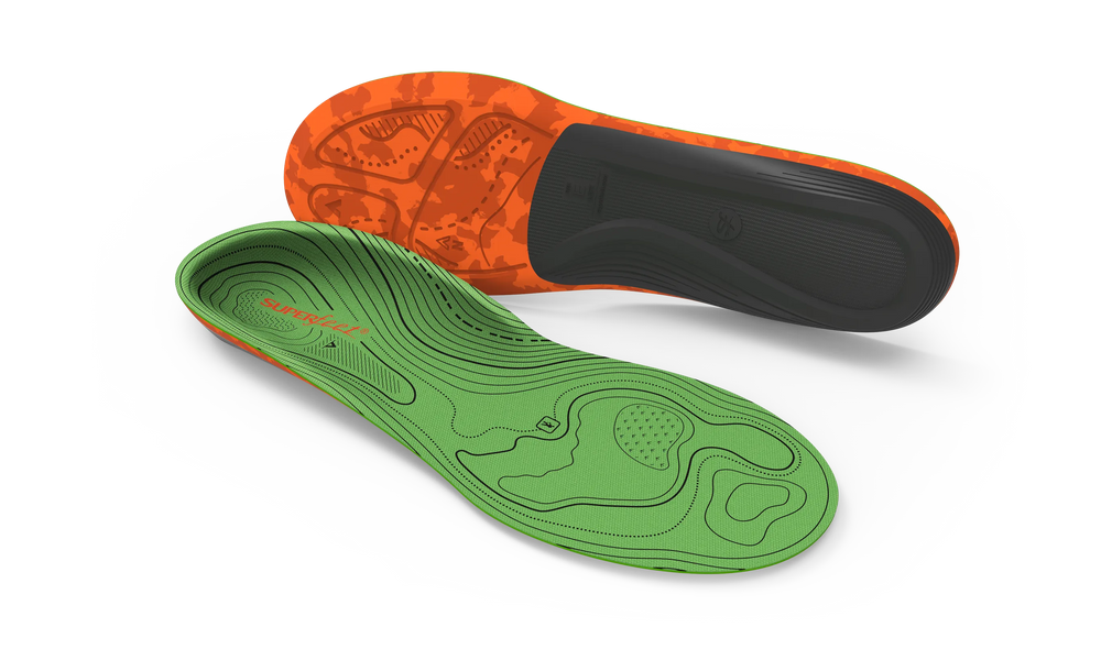 Green and orange shoe insoles on a light gray background