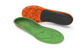 Green and orange shoe insoles on a light gray background