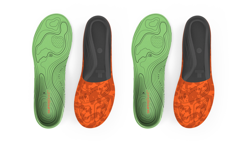 Two pairs of green and orange shoe insoles on a light gray background