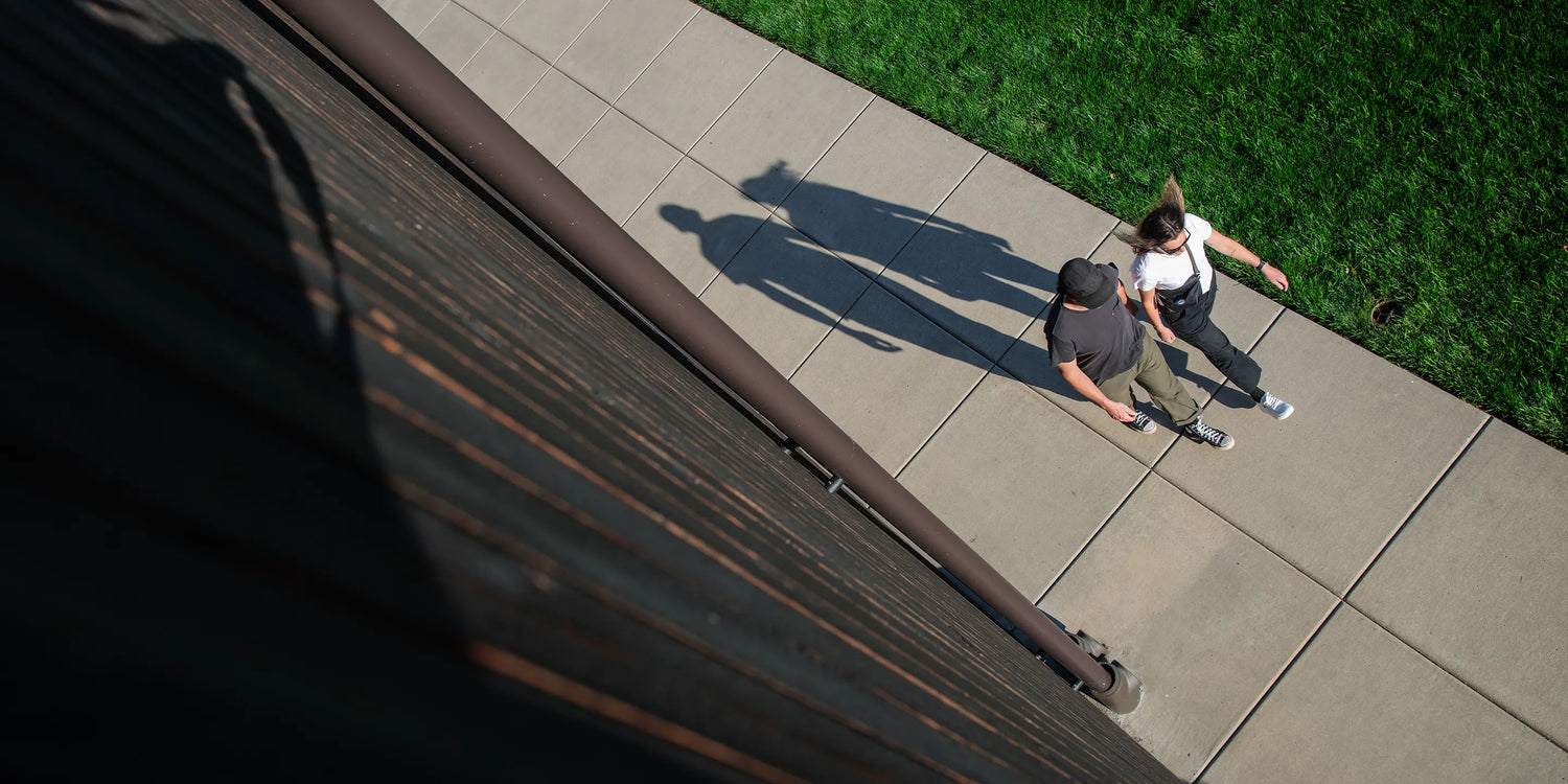 Two people walking outside on sidewalk wearing Superfoot insoles.