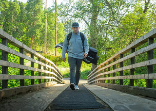 Man walking on golf course carrying his golf bag while wearing Superfeet insoles.